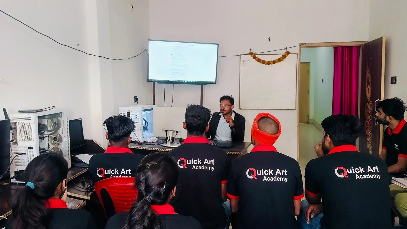 Anil Sharma guiding students in the academy classroom